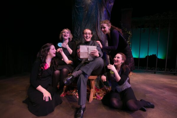 a group of women sitting on a stage