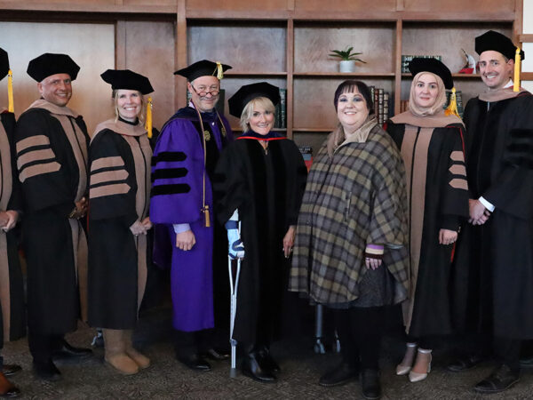 Group of DBA students in cap and gown