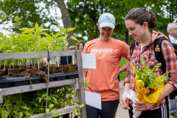 a person and person looking at plants
