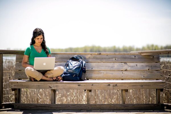 student on a laptop outside