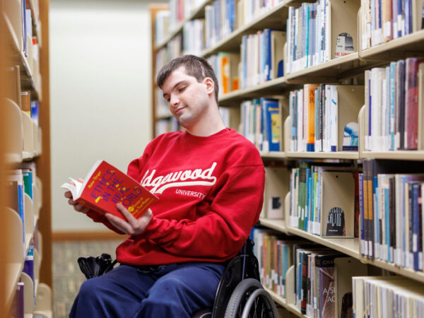 Student reading book in library