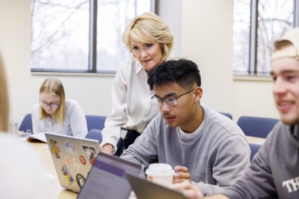 two people looking at a laptop screen