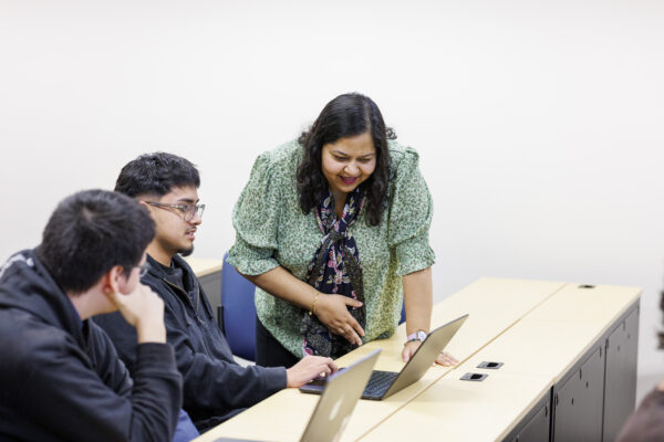 Professor and Student looking at monitor