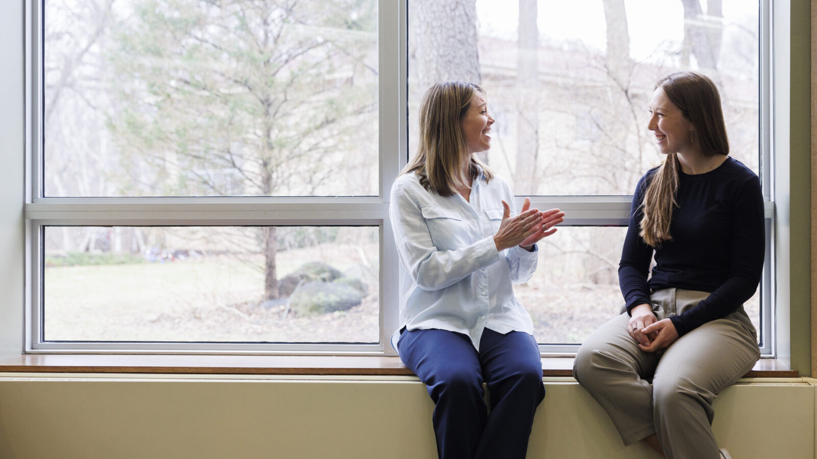 two people talking to each other while sitting.