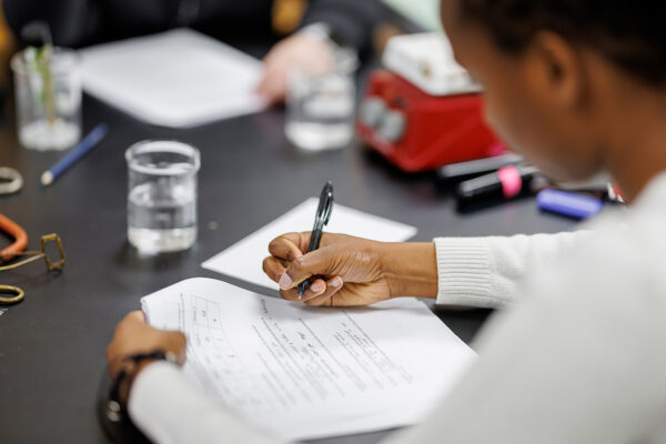 student writing on paper