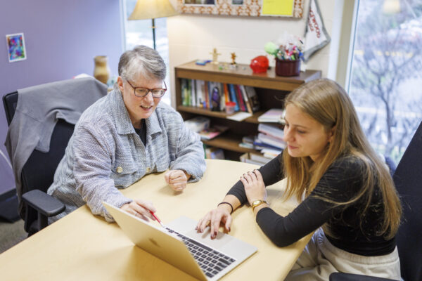 two people looking at laptop screen