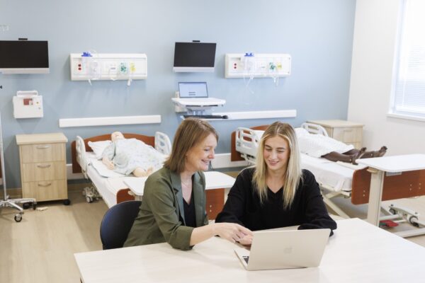 Two people looking at a laptop