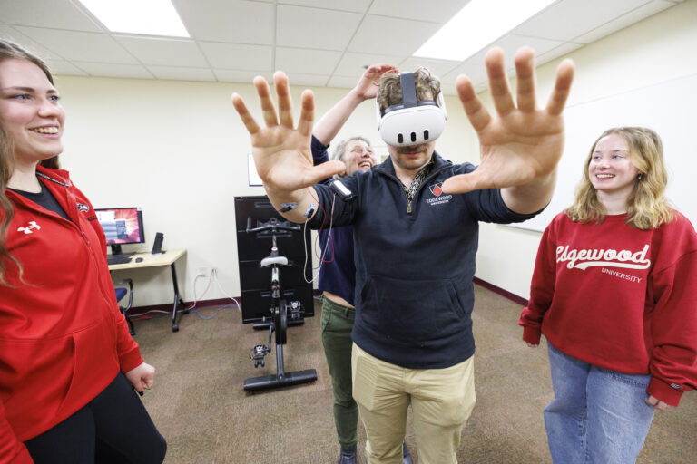 one student with a virtual reality headset on while others watch