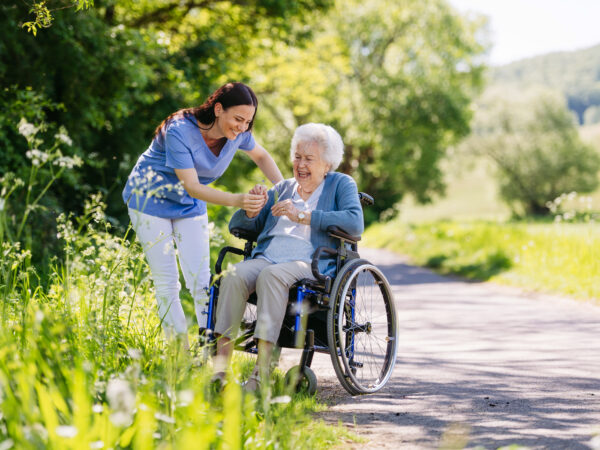 Nurse helping old woman