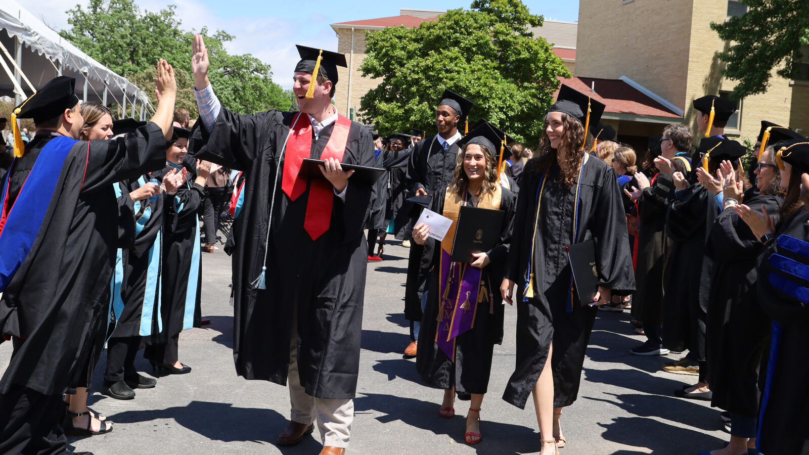 Students in caps and gowns celebrating