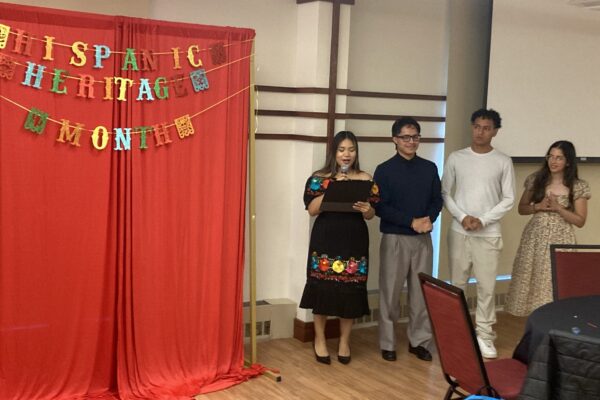 group of students next to a Hispanic heritage month stand