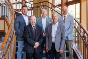 Home Instead representatives pose with two Edgewood University administrators