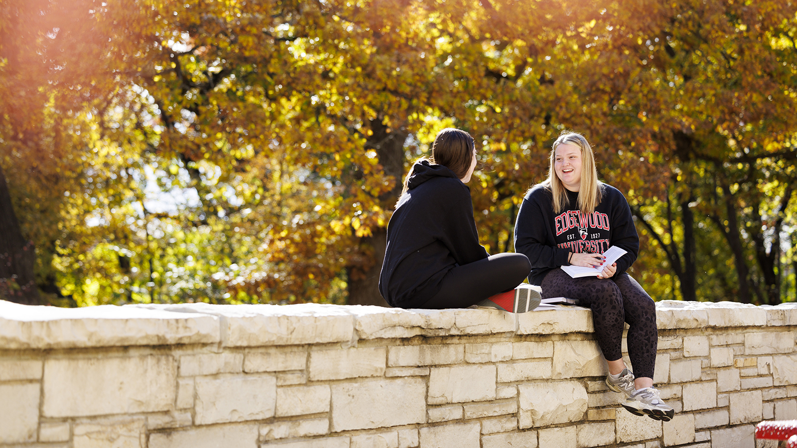 two female students sitting and talking to each other