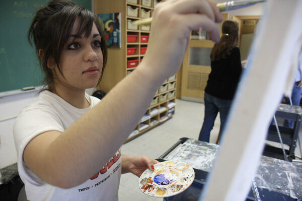 a person painting on a white board