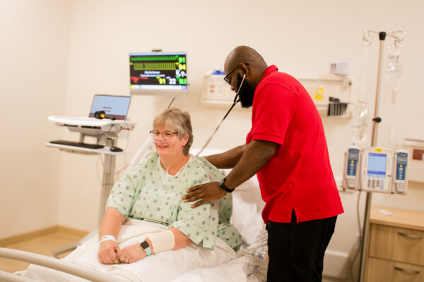 nursing student reading a person's heart rate