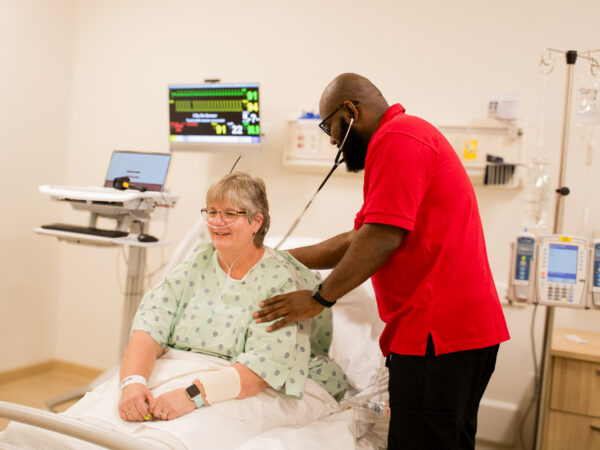 nursing student reading a person's heart rate