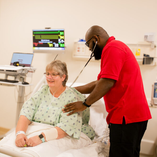 nursing student reading a person's heart rate