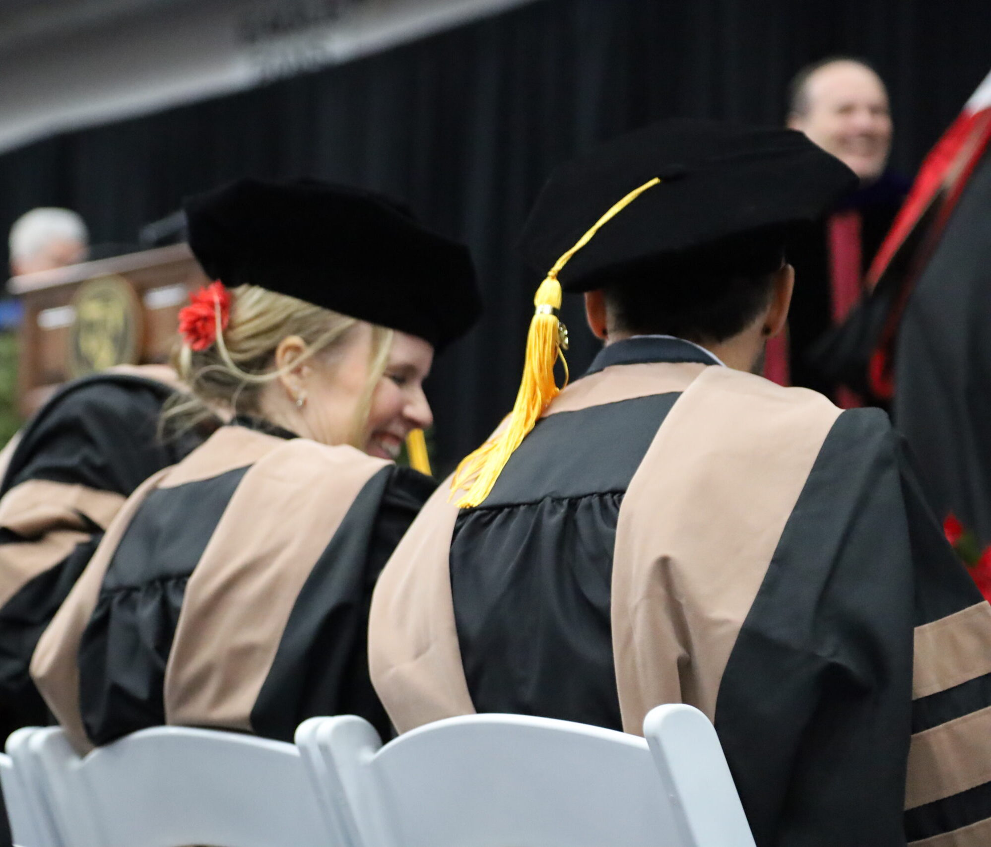 Woman and man in commencement smiling
