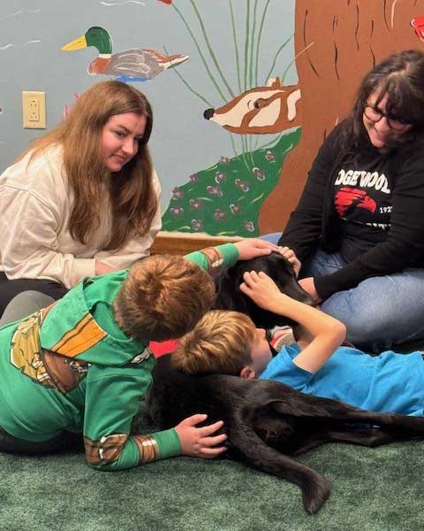 Photo of dog with clients at Gilda's Club, Madison