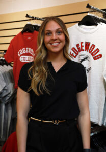 Kallie Norbie smiling in front of Edgewood College Clothes