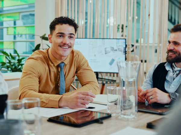 Group of people at a desk smiling