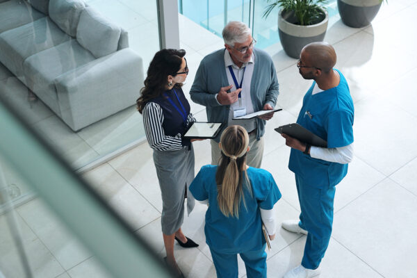 Doctors, medical team and tablet with discussion, advice and above for surgery or patient records. People, tech and nurse for professional opinion, help and results in healthcare, clinic or hospital
