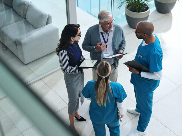 Doctors, medical team and tablet with discussion, advice and above for surgery or patient records. People, tech and nurse for professional opinion, help and results in healthcare, clinic or hospital