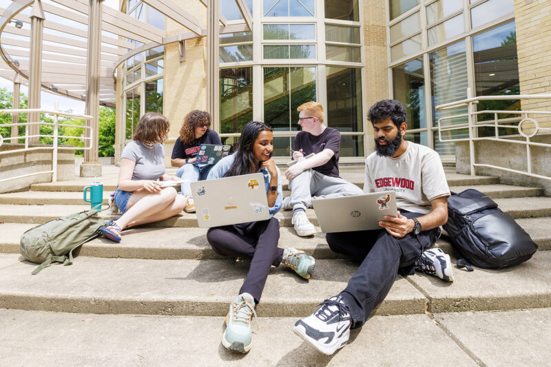 group of students sitting down and talking to each other