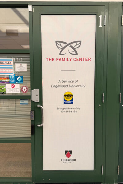 Green door with The Family Center logo